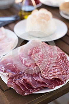 Plate with different cold cuts on a table