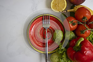Plate of different vegetables and fruits eat  on a light background