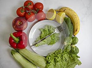 Plate of different vegetables and fruits health on a light background