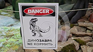 A plate with a dinosau danger zone , do not enter