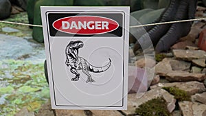 A plate with a dinosau danger zone , do not enter