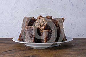 Plate of dodol on wooden table, also called kalu dodol, sri lankan sweet candy dish photo