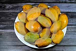 Plate of Egyptian fresh mango fruit with tropical delicacy, mangoes are nutritionally rich fruit with distinctive flavor, smell,