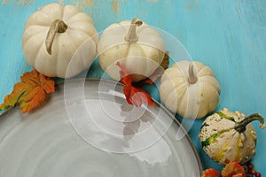 A plate with fall decor and Pumpkins