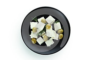 Plate with feta cheese, olives and rosemary isolated on white background