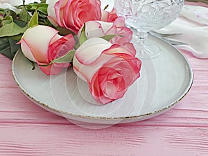 Plate flower rose on wooden background season rustic spring