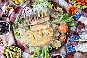 Plate of Food With Fish, Olives, Tomatoes, Lettuce