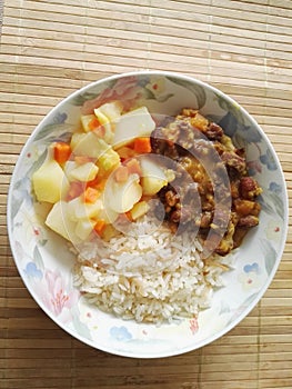 Plate of food with rice, beans and potato photo