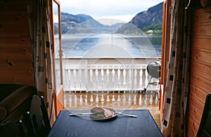 Plate with food on table with lake view