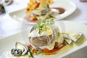 A plate of food waits to be eaten at a fine restaurant