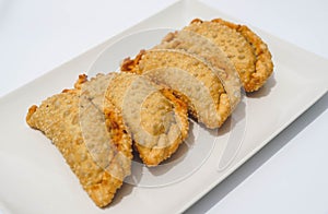 Plate with four fried Argentine beef empanadas