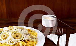 Plate of French fries with coleslaw and onions