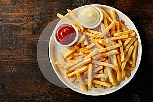 Plate of french fries with sauces with copy space