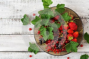 Plate with fresh berries strawberries and currants.