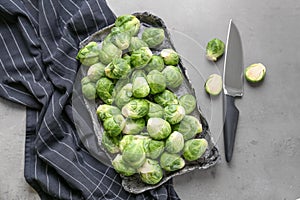 Plate with fresh brussels sprouts on table, top view