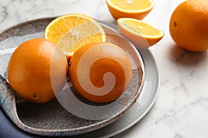Plate with fresh juicy oranges