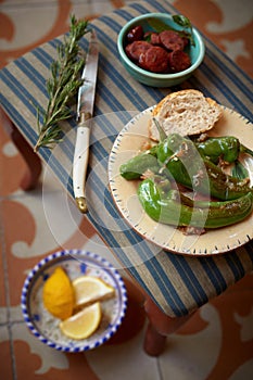 Plate of fresh roasted green chili peppers photo