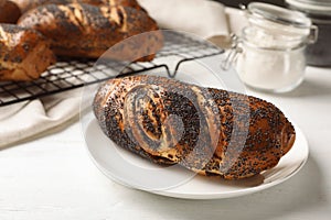 Plate with freshly baked poppy seed roll