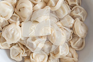 A plate of freshly cooked hot dumplings with a slice of butter melting in them from the temperature to give an appetizing taste