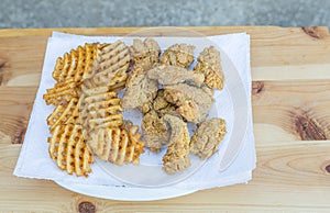 Plate of Freshly Fried Whiting Fish Nuggets and Waffle Fries