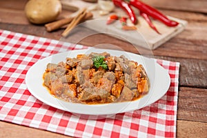 Plate of fried cube beef and pumpkin on the table in restaurant