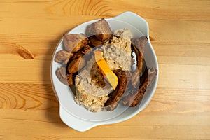 A plate of fried pork with Alentejo-style migas.