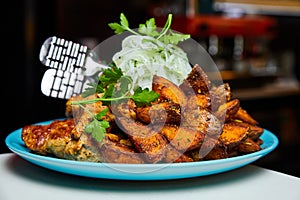 A plate with fried pork barbecue and onion. Close-up, selective focus