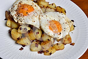 Plate with fried potatoes and fried eggs