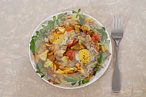 Plate Of Fried Quail Eggs And Vegetables On Hash Browns With Fresh Arugula