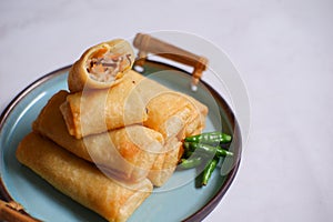 A plate of fried spring roll with vegetable and vermicelli on the table