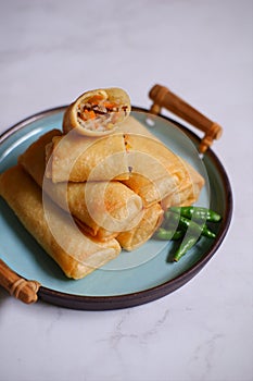 A plate of fried spring roll with vegetable and vermicelli on the table