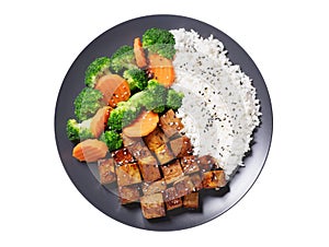 plate of fried tofu, rice and vegetables with sesame seeds isolated on white background