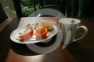 Plate of fruit and coffee mug
