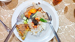 A plate of fu yung hai, cap cay, hong ba, pickles with white rice.