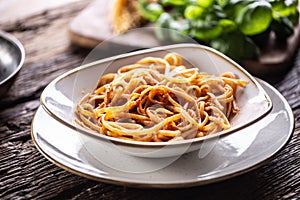 A plate full of freshlz cooked linguini served on a rustic table