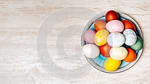 Plate full of multi coloured and mottled Easter eggs