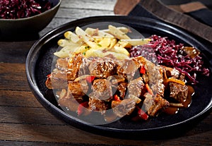 Plate of German beef goulash with red cabbage photo