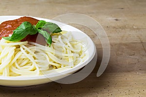 Plate of gluten free spaghetti with tomato sauce and basil