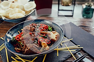 Plate with grilled beef vegetables and chili, chopsticks