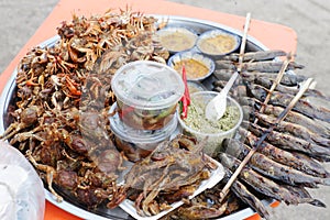 Plate of grilled crabs and fishes sold in a cambodian food market