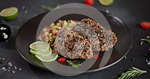 Plate with grilled fried tuna steak covered with sesame seeds and traditional salsa garnish