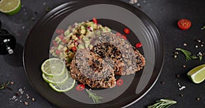 Plate with grilled fried tuna steak covered with sesame seeds and traditional salsa garnish