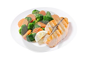 plate of grilled salmon fillet and vegetables on white background