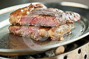 Plate Grilled striploin steak. The strip steak, also called a New York strip. Serving on a wooden Board. Barbecue