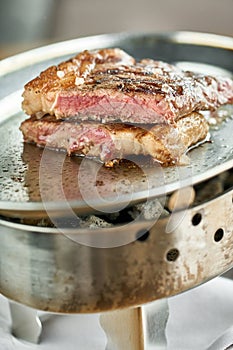 Plate Grilled striploin steak. The strip steak, also called a New York strip. Serving on a wooden Board. Barbecue