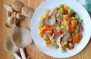 Plate of grilled vegetable salad with fresh Indian Oyster mushrooms on Wooden Table