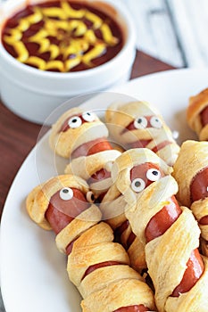 Plate of Halloween Mummy Hot Dogs with Dip photo