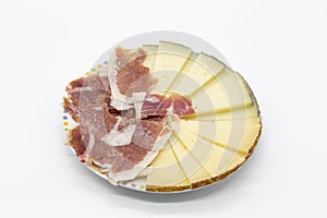 Plate of ham and cheese on white background