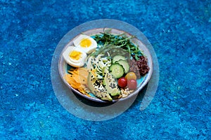 Plate Healhty salad with avocado, egg and fresh vegetables.