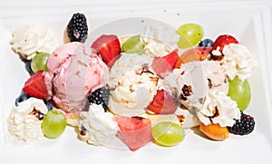 Plate of healthy fresh fruit salad with ice cream. Top view